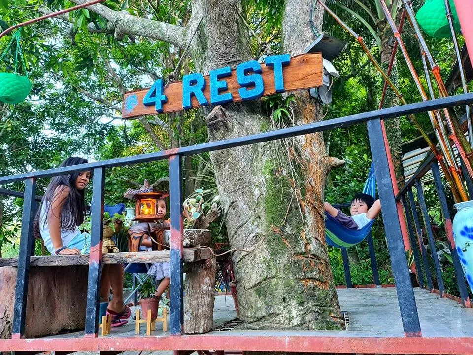 Children relaxing at The 4Rest Resort, Maragondon, with a treehouse and hammock surrounded by lush greenery.