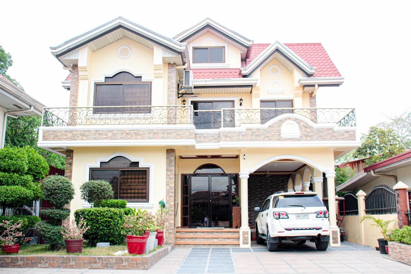 Severina's Lodge in Maragondon with elegant facade, balcony, and parked SUV in the driveway.