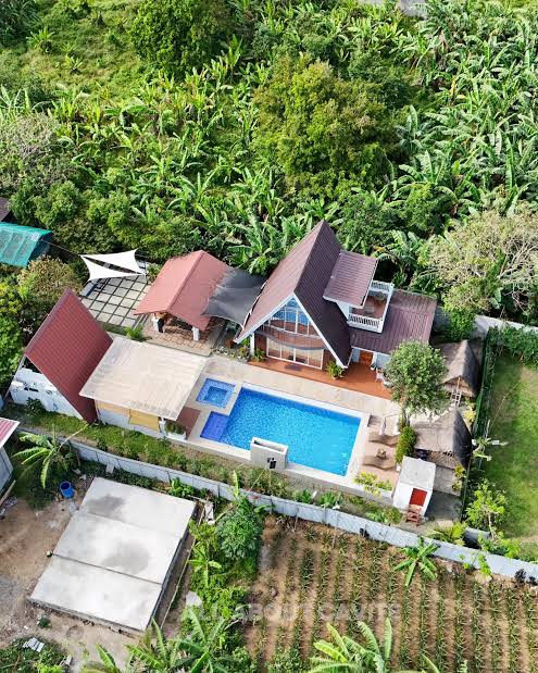 Aerial view of Amadeo Gardens Staycation with a pool, surrounded by lush greenery in Amadeo, Cavite.