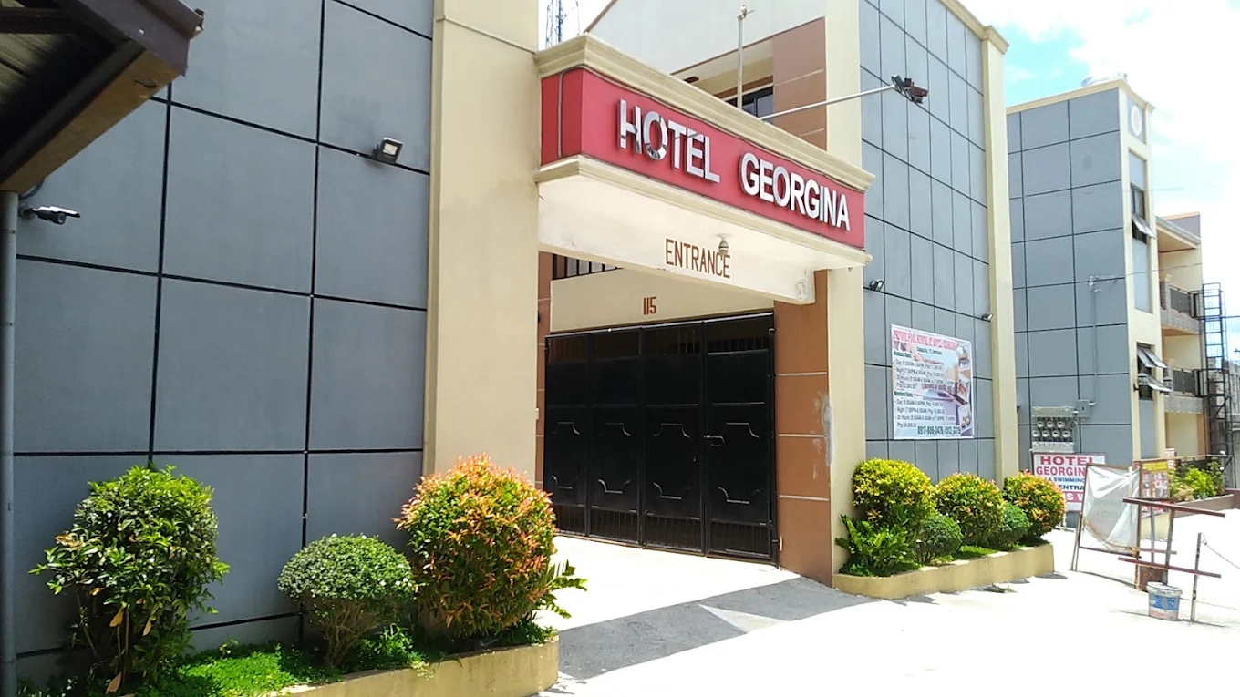 Hotel Georgina entrance with modern facade and landscaped greenery in Amadeo, Cavite.