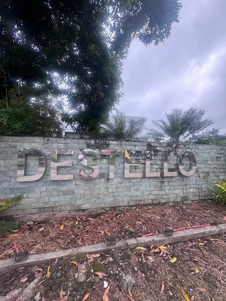 Destello Villas sign on a stone wall surrounded by greenery in Alfonso, Cavite.