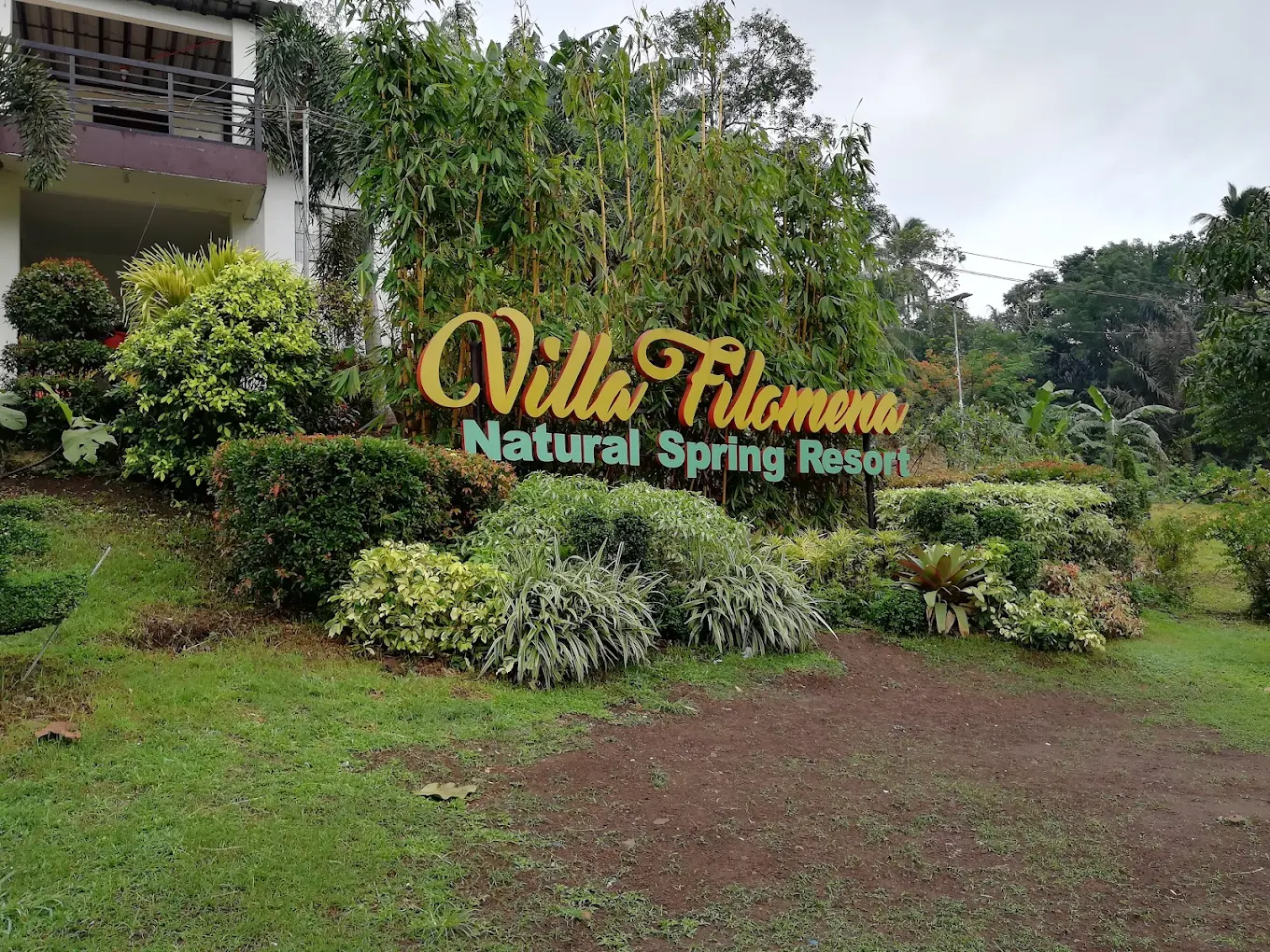 Lush greenery surrounds the sign for Villa Filomena Natural Spring Resort in Indang, Cavite.