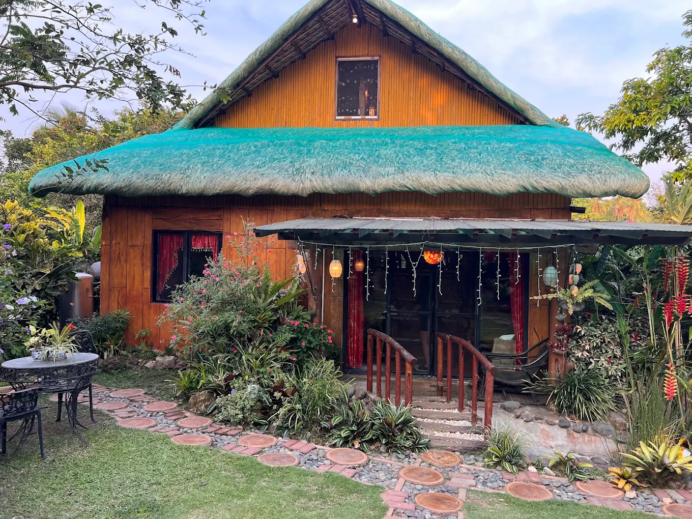 Charming bamboo cottage with a green thatched roof and garden at Moriz Place, Indang, Cavite.