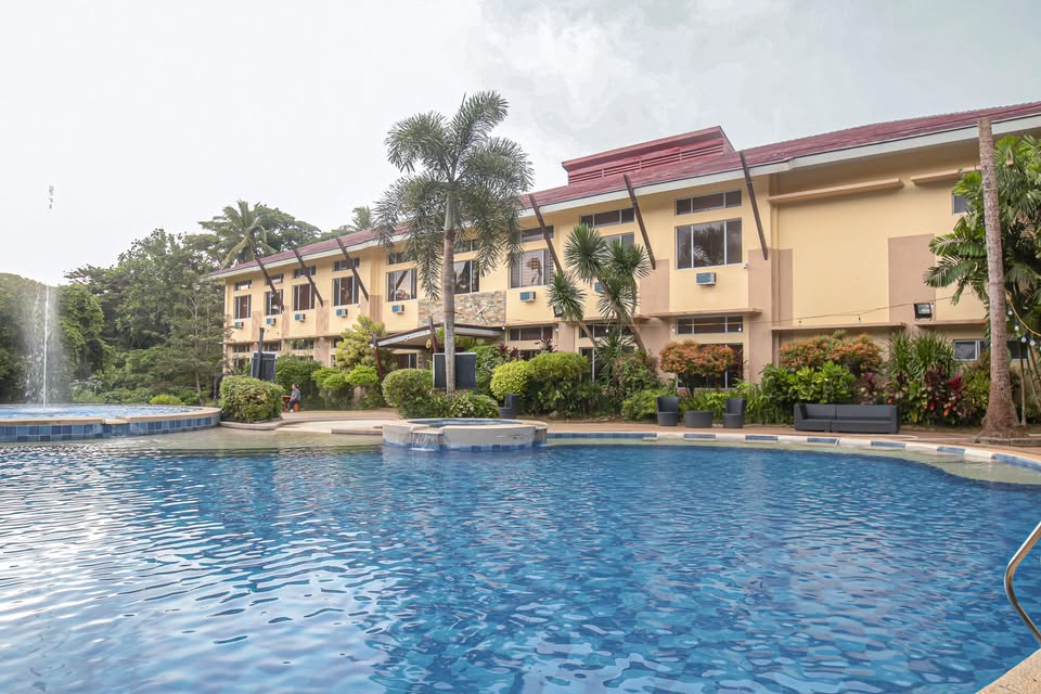 Shalom Hotel in Alfonso with a large swimming pool and lush garden surroundings.