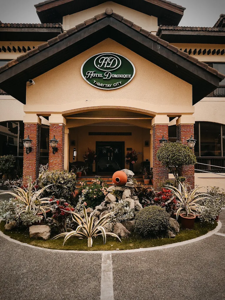 Hotel Dominique entrance in Tagaytay with landscaped garden and prominent signage.
