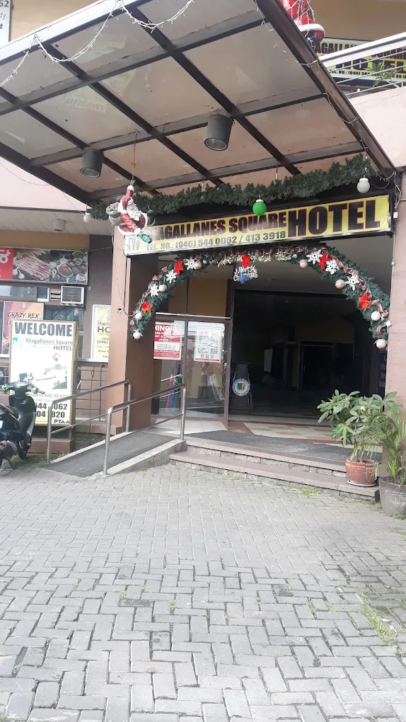 Magallanes Square Hotel entrance in Tagaytay, decorated with festive garlands and a welcoming sign.