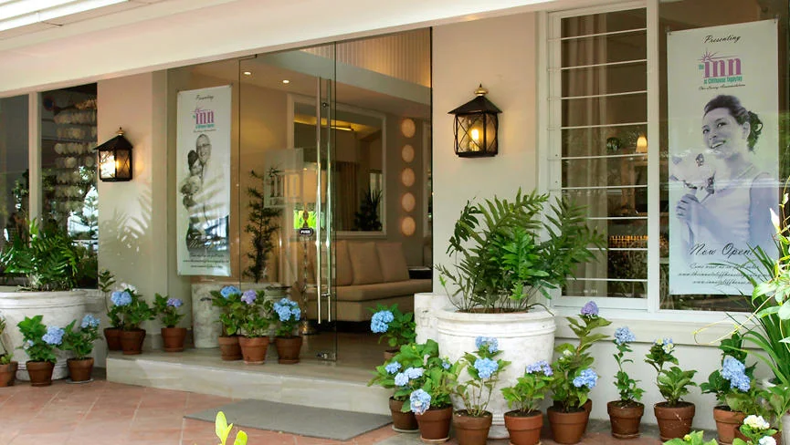 Entrance of The Inn at Cliffhouse Tagaytay with potted plants and glass doors, Tagaytay.