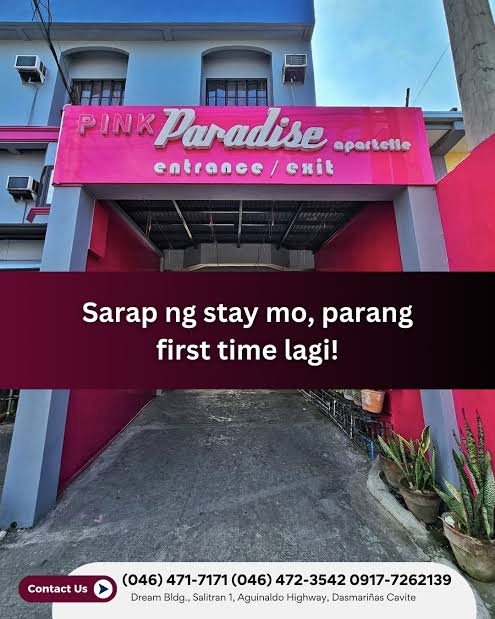 Pink Paradise Apartelle entrance with vibrant pink signage and plants in Dasmariñas, Cavite.