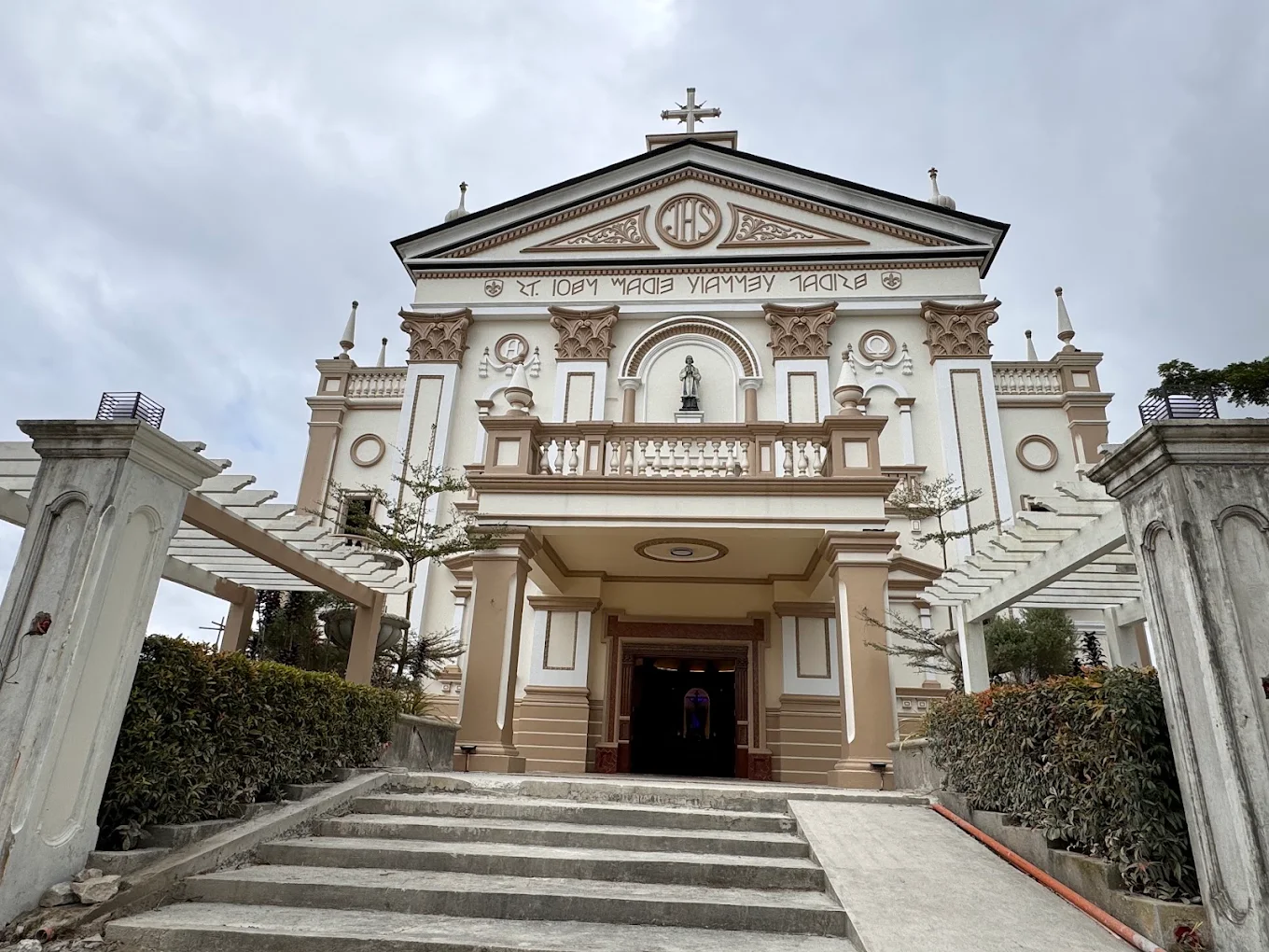 St. John Marie Vianney Parish in Silang, featuring grand entrance steps and ornate architectural details.