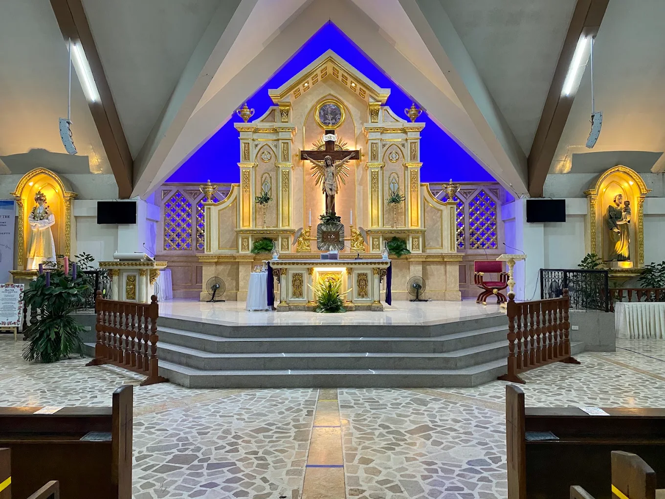 Ornate altar inside the National Shrine of Our Lady of La Salette, Silang, featuring religious statues and vibrant lighting.