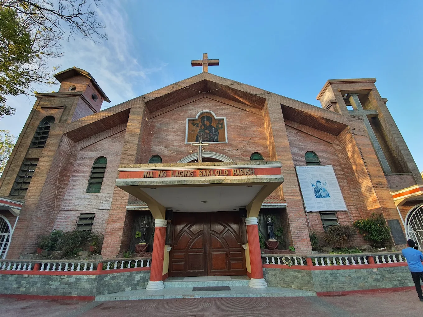 Ina ng Laging Saklolo Parish facade with red brick walls and arched entrance in Tagaytay, Philippines.
